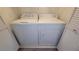 A laundry area features a GE washer and dryer set, with white folding closet doors on either side at 5710 E Tropicana Ave # 2049, Las Vegas, NV 89122