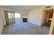 Cozy living room featuring a fireplace, sliding glass doors, and neutral carpeting at 5710 E Tropicana Ave # 2049, Las Vegas, NV 89122