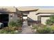 Landscaped entrance with walkway leading to a modern home with stone accents and desert views at 6 Kaya Canyon Way # 14, Henderson, NV 89012