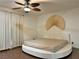 Bedroom featuring hardwood floors, a ceiling fan, and a unique round platform bed with interesting wall art at 6620 Casa Linda Dr, Las Vegas, NV 89103