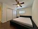 Bedroom featuring modern black bed, hardwood floors, ceiling fan, sliding closet doors at 6620 Casa Linda Dr, Las Vegas, NV 89103