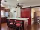 Charming kitchen featuring a central island with seating, a red sliding barn door, and modern stainless steel appliances at 6620 Casa Linda Dr, Las Vegas, NV 89103