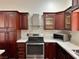 Modern kitchen with marble countertops, dark wood cabinets, and stainless steel appliances, perfect for any home chef at 6620 Casa Linda Dr, Las Vegas, NV 89103