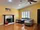 Living room with high ceilings, fireplace, shutters, ceiling fan, wood floors, and comfortable seating at 6620 Casa Linda Dr, Las Vegas, NV 89103