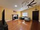 Open living room features a fireplace, shutters, wood floors, ceiling fan, and vaulted ceilings at 6620 Casa Linda Dr, Las Vegas, NV 89103