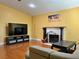 Living room showcasing fireplace, TV, couch and wood floors in this beautiful home at 6620 Casa Linda Dr, Las Vegas, NV 89103