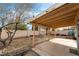 Large backyard featuring a covered patio and a swing set, perfect for relaxation and outdoor entertainment at 715 Rusty Spur Dr, Henderson, NV 89014