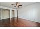 Spacious bedroom with hardwood floors, a ceiling fan, and large closets at 715 Rusty Spur Dr, Henderson, NV 89014