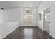 Bright dining area featuring ample natural light, stylish chandelier and wood-look floors at 715 Rusty Spur Dr, Henderson, NV 89014