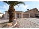 Beautiful home featuring desert landscaping, solar panels, a two-car garage and secure gated entry at 715 Rusty Spur Dr, Henderson, NV 89014