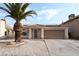 Charming single-story home featuring a well-maintained lawn, desert landscaping and a two-car garage at 715 Rusty Spur Dr, Henderson, NV 89014