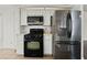 Modern kitchen featuring sleek appliances, tiled floors, and plenty of cabinet space at 715 Rusty Spur Dr, Henderson, NV 89014