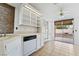 Bright kitchen featuring white cabinets, tile countertops, and a sliding glass door to the backyard at 715 Rusty Spur Dr, Henderson, NV 89014