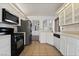 Well-lit kitchen featuring modern appliances, tiled floors and bright cabinetry at 715 Rusty Spur Dr, Henderson, NV 89014