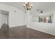 Bright living room with modern flooring, chandelier, and open view of the entry at 715 Rusty Spur Dr, Henderson, NV 89014