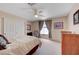 Comfortable bedroom features a ceiling fan and neutral carpet at 7420 Enchanted Hills Ct, Las Vegas, NV 89129
