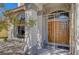 Inviting front entrance with decorative iron gate and double doors at 7420 Enchanted Hills Ct, Las Vegas, NV 89129