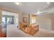 Bright hallway with wooden banister, access to multiple rooms and outdoor balcony at 7420 Enchanted Hills Ct, Las Vegas, NV 89129