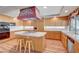 Well-lit kitchen with wood cabinetry, stainless steel appliances, and functional center island at 7420 Enchanted Hills Ct, Las Vegas, NV 89129