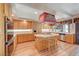 Bright kitchen with wood cabinets, a center island with stovetop, and lots of countertop space at 7420 Enchanted Hills Ct, Las Vegas, NV 89129