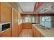 Bright kitchen featuring wood cabinets, stainless steel appliances, and a convenient center island at 7420 Enchanted Hills Ct, Las Vegas, NV 89129