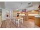 Bright kitchen showcasing wood cabinetry, an island cooktop, and dining area with ample counter space at 7420 Enchanted Hills Ct, Las Vegas, NV 89129
