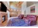 Spacious living room featuring a fireplace, bar, and backyard access at 7420 Enchanted Hills Ct, Las Vegas, NV 89129