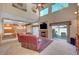 Open floor plan with living room featuring a fireplace and backyard access, with natural light and views at 7420 Enchanted Hills Ct, Las Vegas, NV 89129