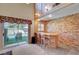Cozy wet bar with brick surround, ideal for entertaining guests near the bright pool area at 7420 Enchanted Hills Ct, Las Vegas, NV 89129