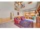 Open-concept living room with views of the staircase and kitchen area, with a fireplace at 7420 Enchanted Hills Ct, Las Vegas, NV 89129