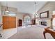 Open living room featuring fireplace, arched window, and double door entry at 7420 Enchanted Hills Ct, Las Vegas, NV 89129