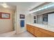 Bright bathroom featuring double sinks, soaking tub, and glass-enclosed shower at 7420 Enchanted Hills Ct, Las Vegas, NV 89129