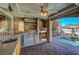 Inviting outdoor kitchen featuring a stone fireplace, stainless grill, and a view of the pool at 7420 Enchanted Hills Ct, Las Vegas, NV 89129