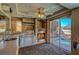 Inviting outdoor kitchen featuring a stone fireplace, stainless grill, and a view of the pool at 7420 Enchanted Hills Ct, Las Vegas, NV 89129