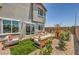 Landscaped backyard featuring modern patio furniture, a playhouse, gravel groundcover, and a well-maintained lawn at 7449 Bosco Dr # Lot 106, North Las Vegas, NV 89084
