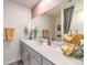 Bathroom with gray cabinets, modern fixtures, and decorative towels by a large, well-lit mirror at 7449 Bosco Dr # Lot 106, North Las Vegas, NV 89084
