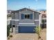 Charming two-story home with blue garage door, shutters, and brick driveway at 7449 Bosco Dr # Lot 106, North Las Vegas, NV 89084