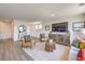 Cozy living room with stylish furniture, area rug, and a large TV at 7449 Bosco Dr # Lot 106, North Las Vegas, NV 89084