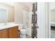 Clean bathroom with wood-look flooring, a shower-tub combo, and a neutral vanity at 7486 River Dove Ct, Las Vegas, NV 89139