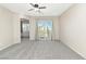 Spacious bedroom with carpet flooring and sliding glass doors leading to a balcony at 7486 River Dove Ct, Las Vegas, NV 89139