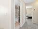 Hallway view leading to a bathroom and bedroom with neutral paint and carpet at 7486 River Dove Ct, Las Vegas, NV 89139