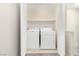 Convenient laundry room equipped with modern washer and dryer units, complete with shelving at 7486 River Dove Ct, Las Vegas, NV 89139