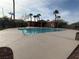 Community pool featuring palm trees, lounge area, and a pool house with a seating area at 7486 River Dove Ct, Las Vegas, NV 89139