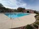 Community pool with clear blue water, surrounded by well-maintained landscaping and a pool house at 7486 River Dove Ct, Las Vegas, NV 89139