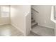 Carpeted staircase with white railing and natural light from a nearby window at 7486 River Dove Ct, Las Vegas, NV 89139