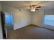 Spacious bedroom featuring neutral carpeting, ceiling fan and a large window for natural light at 8250 N Grand Canyon Dr # 2085, Las Vegas, NV 89166