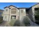 An exterior view of a two-story apartment building featuring stair access to the upper level at 8250 N Grand Canyon Dr # 2085, Las Vegas, NV 89166