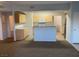 A well-lit kitchen featuring wooden cabinets, a microwave, and an island with room for seating at 8250 N Grand Canyon Dr # 2085, Las Vegas, NV 89166