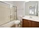 Bathroom with shower-tub combo, vanity, and neutral finishes with a window to the bedroom at 8348 Nelson Ridge Ln, Las Vegas, NV 89178