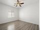 Bedroom with wood floors, white walls, ample natural light, and a ceiling fan at 8348 Nelson Ridge Ln, Las Vegas, NV 89178